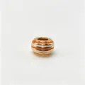 Close-up of gold plated colorful striped charm bead, stylish DIY jewelry accessory detail. - M09