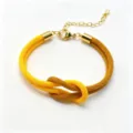 Detailed close-up of the two-color braided rope bracelet featuring a knot and gold chain. - Size 8