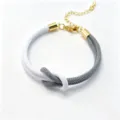 Two-tone braided Milan rope bracelet with figure-eight knot and gold-colored adjustable chain. - Size 10