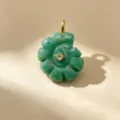 Close-up detail of green natural stone carved spiral shell pendant with gold bail and crystal. - Single Pendant (Chain Not Included) / 03 Amazonite