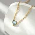 Closeup of gold plated steel necklace with light blue heart shaped crystal pendant. - Heart Rhinestone Sky Blue - x1322