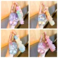 Close up detail of the cute liquid water game machine keychain with unicorn design and straps. - Unicorn Style / 7.8x4.8cm