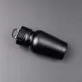 Close-up detail of the black aluminum alloy waterproof pill container with a hanging loop. - Black