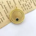 Detailed close-up of a retro gold sunray coin pendant featuring a central black zircon stone. - Style A