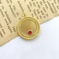 Close-up of retro gold sunburst pendant with red zircon on vintage paper background detail. - Style B