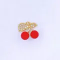 Gold-plated cherry pendant detail, featuring sparkly zirconia leaves and vivid red fruit. - Style B