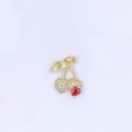 Exquisite cherry pendant detail featuring sparkling micro-pave cubic zirconia and a red heart crystal. - Style A