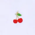 Close-up detail of a cute 3D cherry charm, gold-plated copper with red and green enamel. - Style D