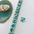 Close-up detail of stainless steel Italian charm bracelet with green crystal star DIY links. - Faceted Star Style (Style 4)