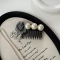Detail view of vintage grey rose fabric hair comb with elegant white pearls for styling. - Gray Flower Style / Gray