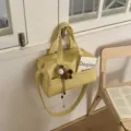 Stylish yellow leather tote shoulder bag with top handles, crossbody strap and cute charm. - With Horse Charm / Yellow