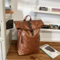 Vintage brown PU leather roll-top backpack for men and women, stylish casual travel school bag. - Brown