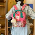 Pink heart print casual backpack with transparent front pocket and cute plush keychain accessory. - Pink + Cheese Pendant