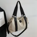 Beige travel duffel bag for men and women, large capacity waterproof weekender bag with shoulder strap. - Beige