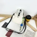 Casual canvas crossbody bag for women, lightweight small backpack with stylish strap design. - With Pendant / Off White