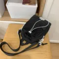 Black casual mini backpack with white drawstring, lightweight portable water bottle shoulder bag. - Black