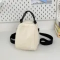 Off-white small canvas backpack with black rope handle, versatile casual daypack for women. - White