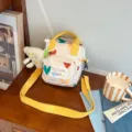 Cute cartoon canvas crossbody bag, stylish small shoulder bag with hearts and yellow strap. - Beige + Cheese Pendant