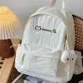 Detailed view of a casual white school backpack with cute plush pendant and embroidery. - White with Cat