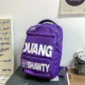 Grand sac à dos violet de style workwear avec lettrage audacieux pour voyage et école. - Violet