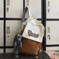 Two-tone canvas backpack in white and brown with cute doll pendant, stylish school travel bag. - Brown Small + Grey Frog