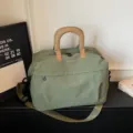 Green expandable large travel duffel bag with cute bow embroidery and sturdy handles. - Green