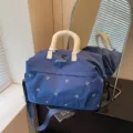 Large capacity blue travel duffel bag with bow embroidery and shoulder strap for short trips. - Blue