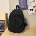Black lightweight casual backpack for daily school travel with zip pocket and cute pendant - Charm Style (Soot Sprite) / Black
