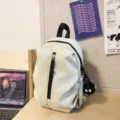 Casual lightweight mini backpack for women and students with front zipper pocket and cute charm. - Charm Style (Soot Sprite) / White