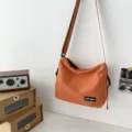 Minimalist canvas messenger bag for women, stylish orange crossbody shoulder bag for daily casual use. - Basic Style / Orange