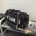 Black travel duffel bag with large capacity, dry-wet separation, and stylish striped straps. - Black
