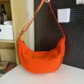 Large capacity orange crescent crossbody bag for women and men, lightweight casual nylon shoulder bag. - Orange