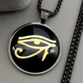 Closeup of stainless steel Eye of Horus pendant necklace with gold symbol detailing. - Black 60cm
