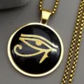 Close-up detail of the vintage gold Eye of Horus pendant necklace, elegant metallic texture. - Gold 60cm