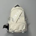 Großer, beigefarbener Schulrucksack für Studenten mit stilvollem Design und Affenanhänger. - Weiß + Schimpanse