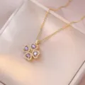 Goldfarbene vierblättrige Kleeblatt Anhänger Halskette mit violetten glänzenden Steinen. - Herz Rotierender Kleeblatt-Stil (X3342) / Gold mit Lila