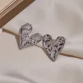 Metallic irregular heart stud earrings detail view, showing unique textured design and glossy finish. - Irregular Heart Style (1138) / Silver