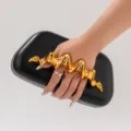 Elegant black PU clutch bag with luxury gold wavy knuckle handle for evening party dress. - Black