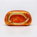Amber acrylic evening clutch bag with striking sculptural gold metal ring handle. - Acrylic Orange