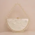 Elegant pearl handle acrylic half-circle evening clutch bag in champagne marbled finish. - Milky White