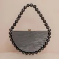 Black marbled acrylic semi-circular evening clutch bag with matching statement bead handle. - Black