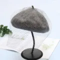 Close-up of the elegant grey wool beret with mesh veil, showcasing fine texture and retro style. - Adjustable / Extended Tulle - Gray