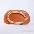 Orange leather clutch bag with a unique gold sculptural handle for women evening party. - Leather Orange