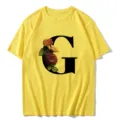 Yellow short-sleeve T-shirt featuring a stylish black letter G and vintage floral print design. - S / Tops / Letter G