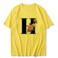 Yellow short sleeve t-shirt featuring a large black letter H print with vintage floral style. - S / Tops / Letter H