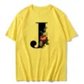 Close-up view of the yellow short sleeve T-shirt featuring a chic floral letter J print. - S / Tops / Letter J
