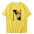 Detailed view of yellow casual short-sleeve t-shirt featuring elegant floral letter N print. - S / Tops / Letter N