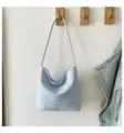 Light blue hobo shoulder bag detailed view featuring all-over silver star prints and sleek strap. - Blue