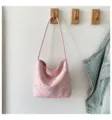 Pink star shoulder bag detail view, hanging on wooden hook with casual daily lifestyle setting. - Pink