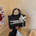 Black star embroidered canvas tote bag with stylish silver star pendant for daily women use. - No Pendant / Black